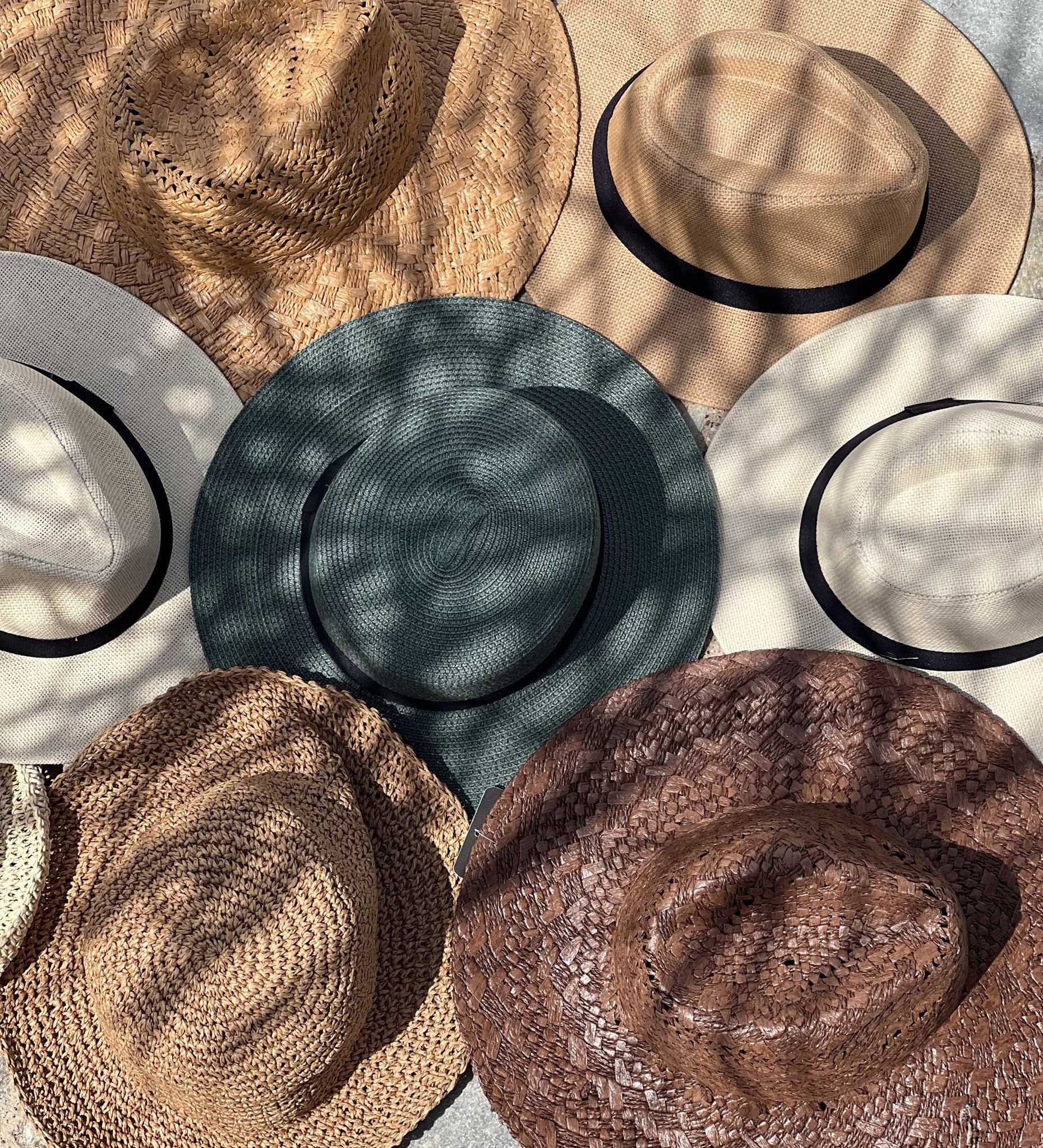 Collection of various hats arranged on a flat surface